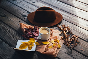 brown hat with white ceramic coffee mug