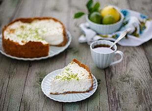 piece of pie on white ceramic saucer beside teacup