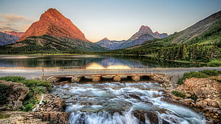 gray concrete bridge on top of body of water