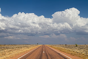 road under cloudy sky during daytime