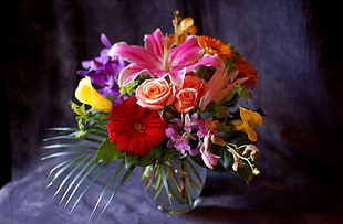 variety of flowers with black vase