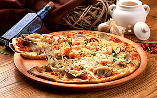 pizza with mushroom and cheese served on brown plate ] HD wallpaper