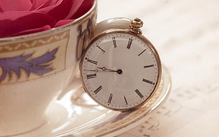 gold-colored pocket watch on top of white saucer near cup HD wallpaper