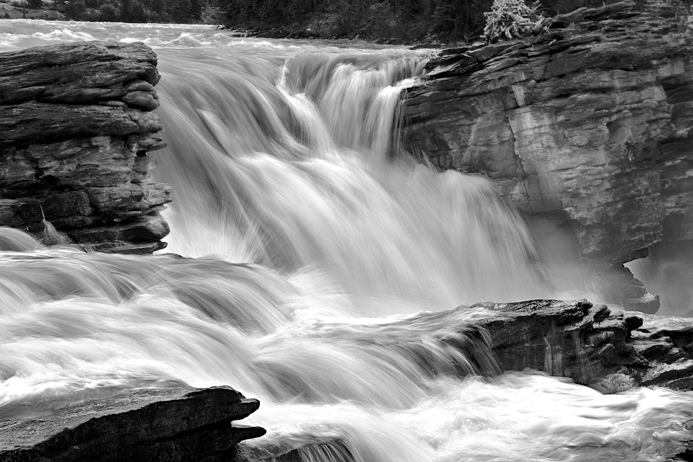 time lapse photography of water falls surrounded by rocks