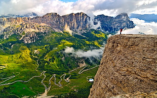 man standing in brown rocky cliff