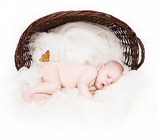 baby sleeping on white textile near basket HD wallpaper