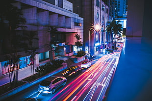 timelapse photo of a street beside buildings