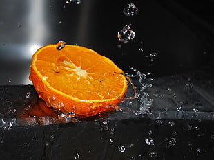 sliced orange fruit with water drops