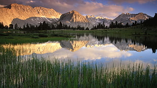 rock mountain reflecting on water