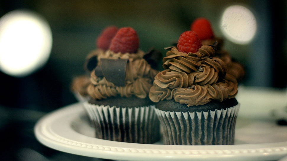 four cupcakes with strawberry toppings placed on round white ceramic plate HD wallpaper