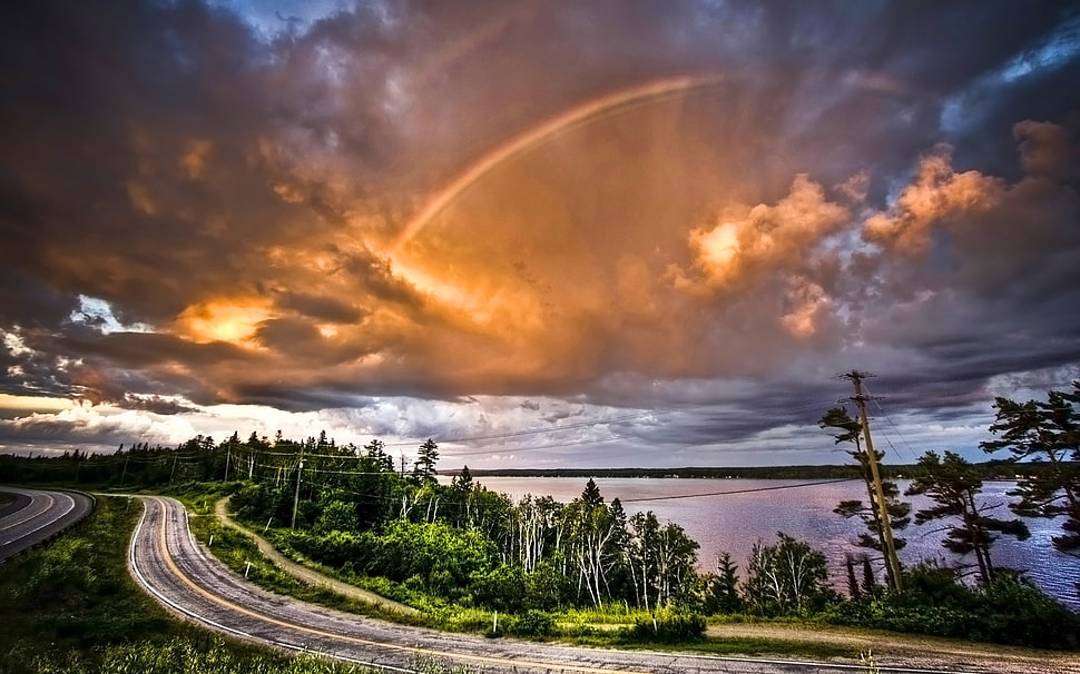 brown and white house near river painting, coast, sky, road, clouds HD wallpaper