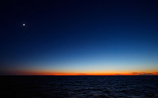 body of water during sunset