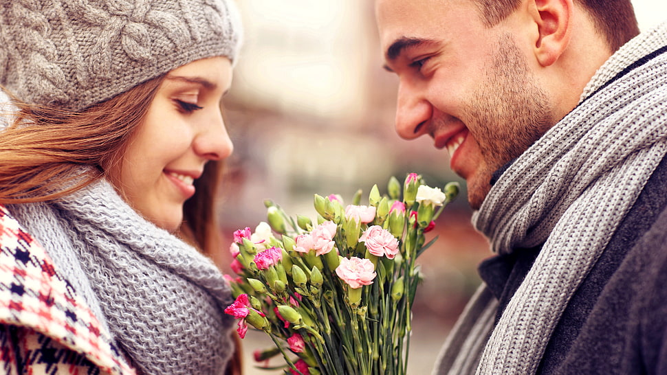 shallow focus photography of woman and man holding flower bouquet HD wallpaper