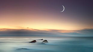 crescent moon during golden hour