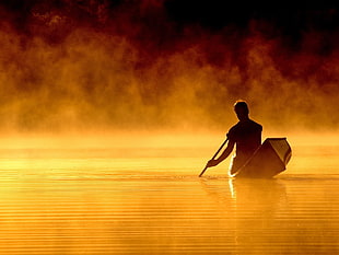 silhouette of man passing body of water HD wallpaper