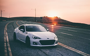 silver sports car on asphalt road at sunset HD wallpaper