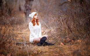 woman in white long-sleeved shirt and black knee-high boots sits on wood ruding daytime HD wallpaper