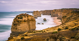 photography of seashore near mountain