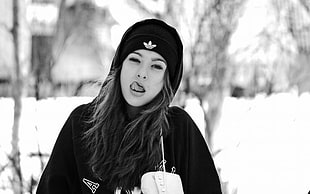 grayscale photo of woman wearing jacket and knit cap showing tongue HD wallpaper