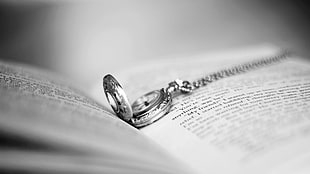 silver-colored necklace on book HD wallpaper