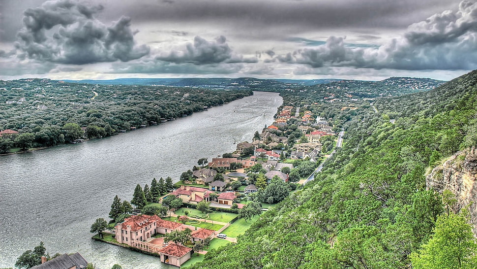 aerial photo of village surrounded with body of water and trees HD wallpaper