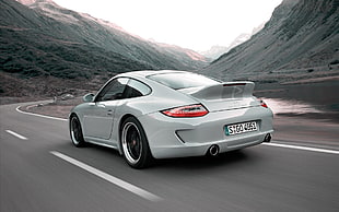 white Porsche 911 running on road during daytime