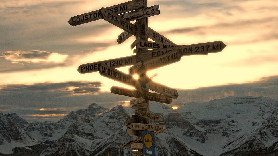 signage in the middle of mountains at golden hour HD wallpaper