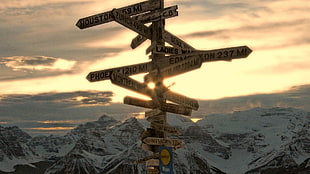 signage in the middle of mountains at golden hour