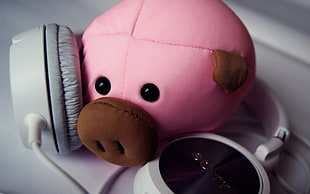 photo of pink pig plush toy beside white headphones HD wallpaper
