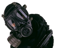 person wearing black gas mask