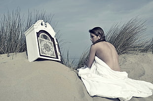 topless woman sitting on sand photogoraph HD wallpaper