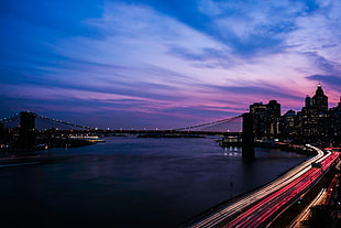 time-lapse photo of vehicles near the bridge