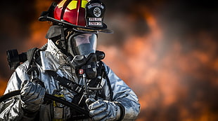 selective photo of fireman holding hose HD wallpaper