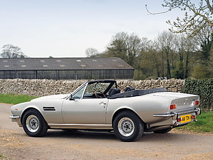 grey convertible on sandy road