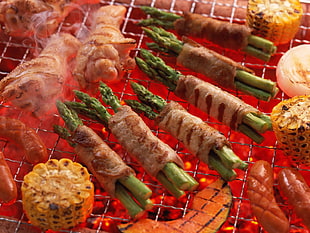 food photography of corn cob and vegetable wrapped with meat grill
