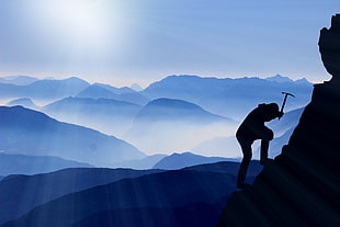 man climbing while holding pick axe painting