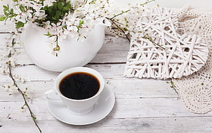 white ceramic tea cup and saucer with black coffee on wooden table near ceramic vase HD wallpaper