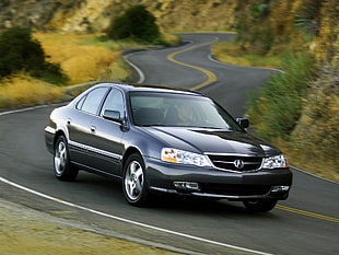 black Acura on road at daytime