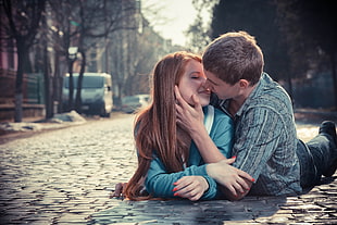 couple on street kissing during daytime