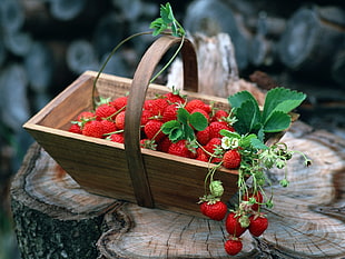 strawberry on brown wooden basket