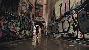 silhouette of person standing at hallway between walls with graffiti HD wallpaper