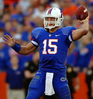 focus photography of a Football player number 15 throwing ball