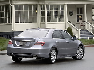 silver sedan on gray asphalt road