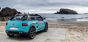 blue Citroen C4 Cactus parked in front body of water at daytime HD wallpaper