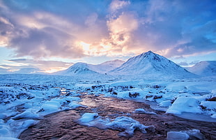 Snow covered mountain beside body of water HD wallpaper