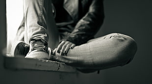 gray scale portrait of person wearing basketball shoes