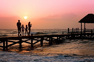 silhouette of family in river