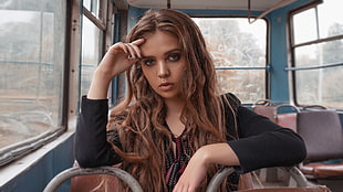 photo of woman wearing black long-sleeved top sitting inside bus HD wallpaper