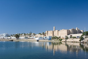 white castle beside body of water