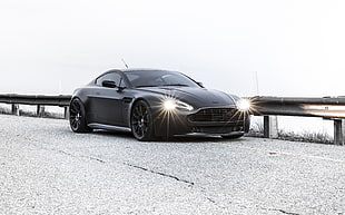 black coupe with open headlights